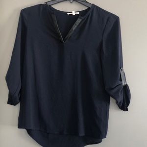 Dark blue top with black leather accents.